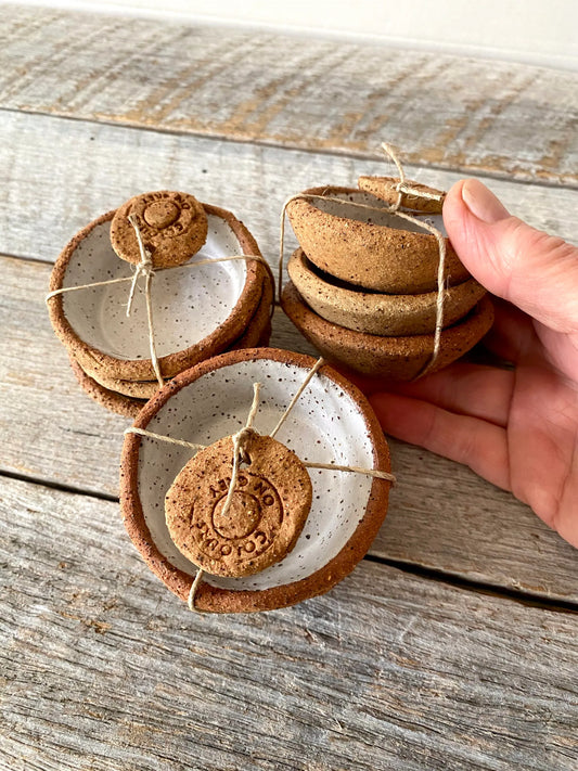 A set of 3 small hand formed trinket bowls. Rustic clay with speckled white glaze.  (6-01)