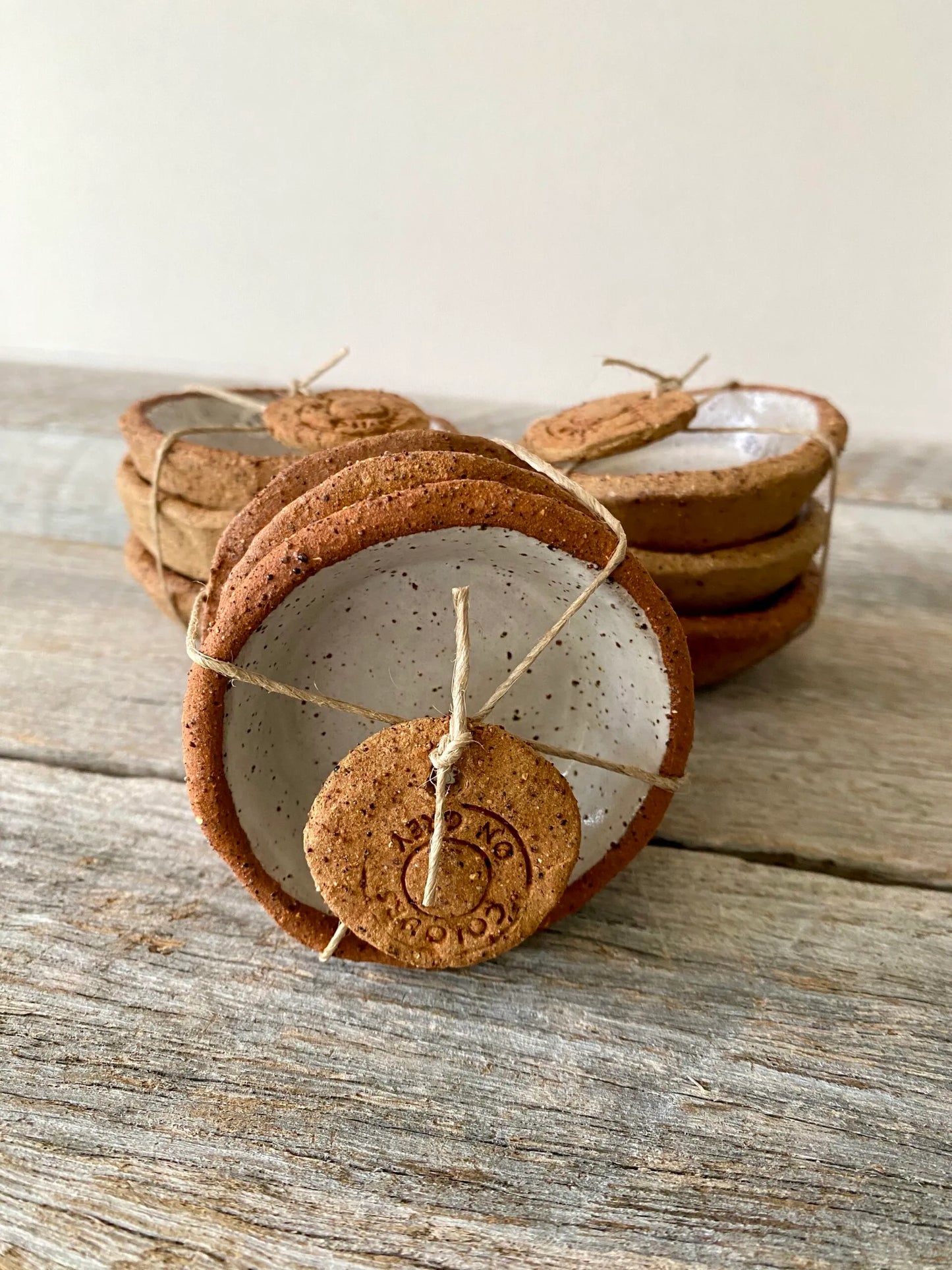 A set of 3 small hand formed trinket bowls. Rustic clay with speckled white glaze.  (6-01)