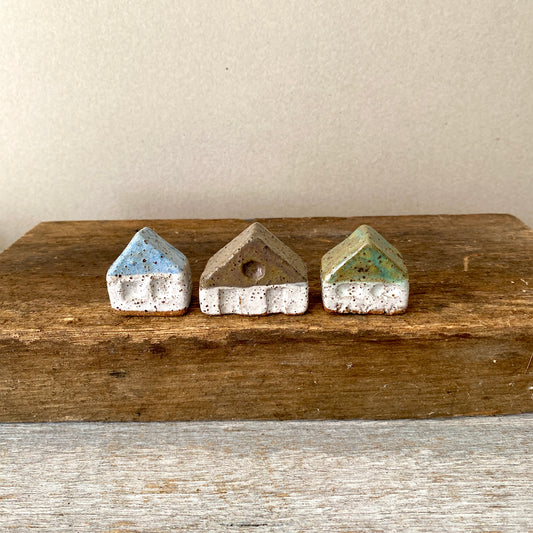 A collection of 3 cute tiny cottages with door, windows and decorations on all sides 55-02